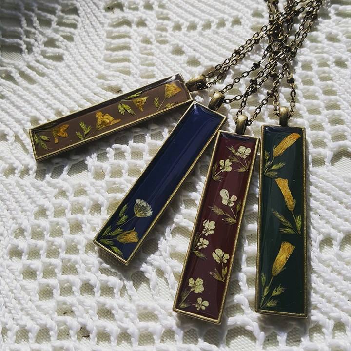 Necklaces with colored pendants with flower designs