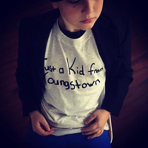 A young boy wearing a gray 
