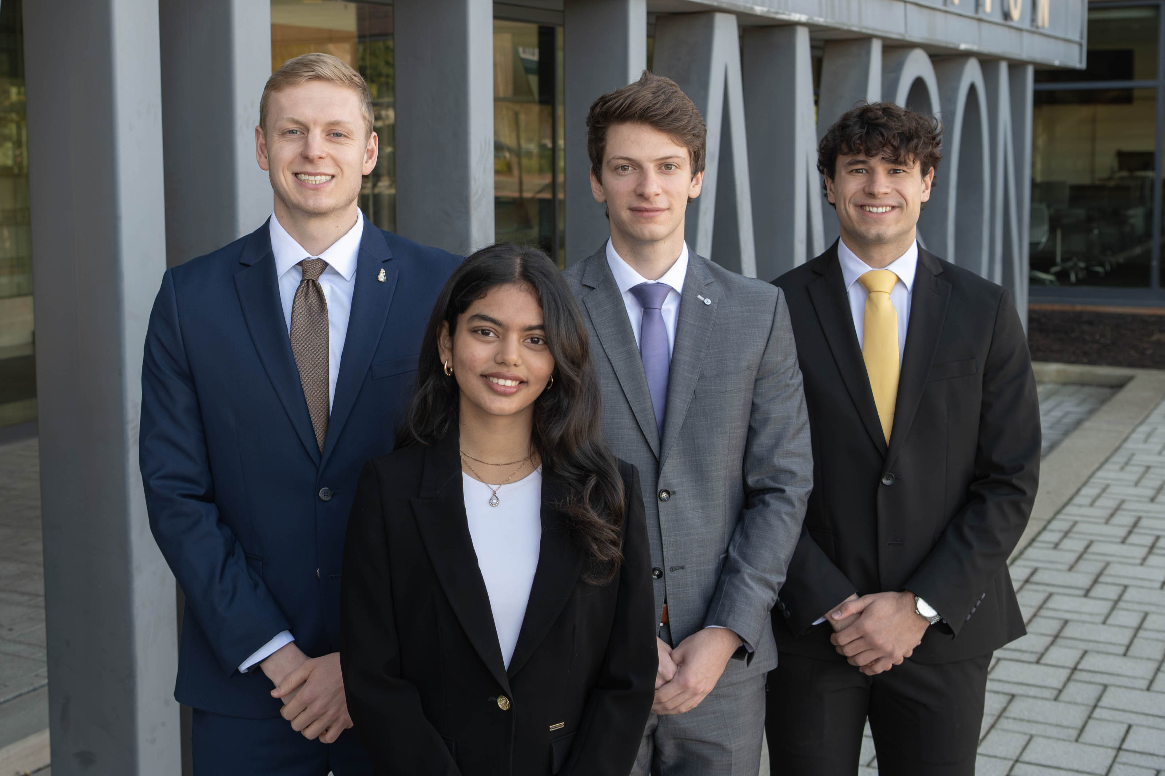 James Slessor, Tanishka Agnihotri, Jan Harter, and Moritz Bayer posing outside of WCBA