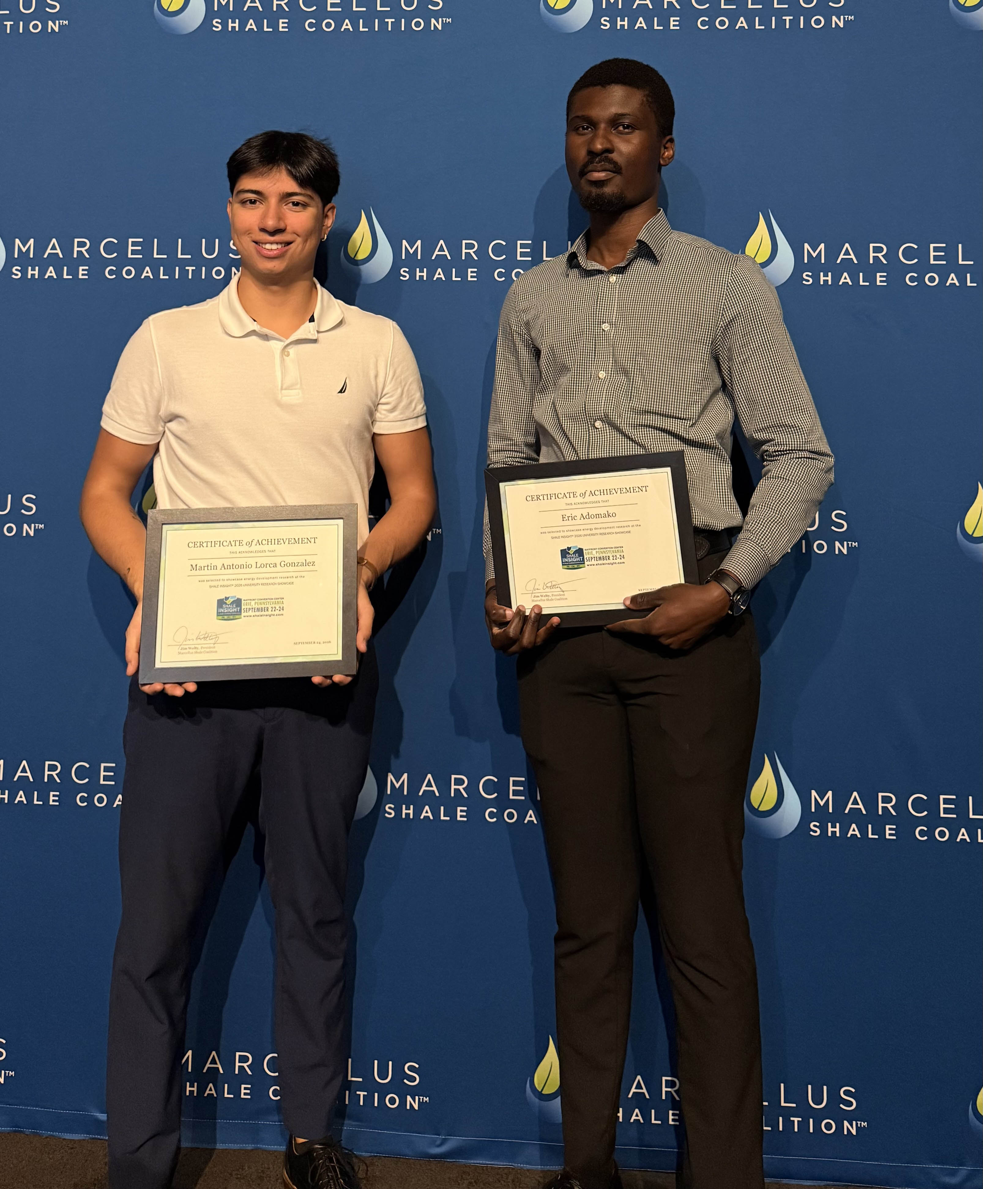 Martin Antonio Lorca and Eric Adomako pose with certificates of achievement