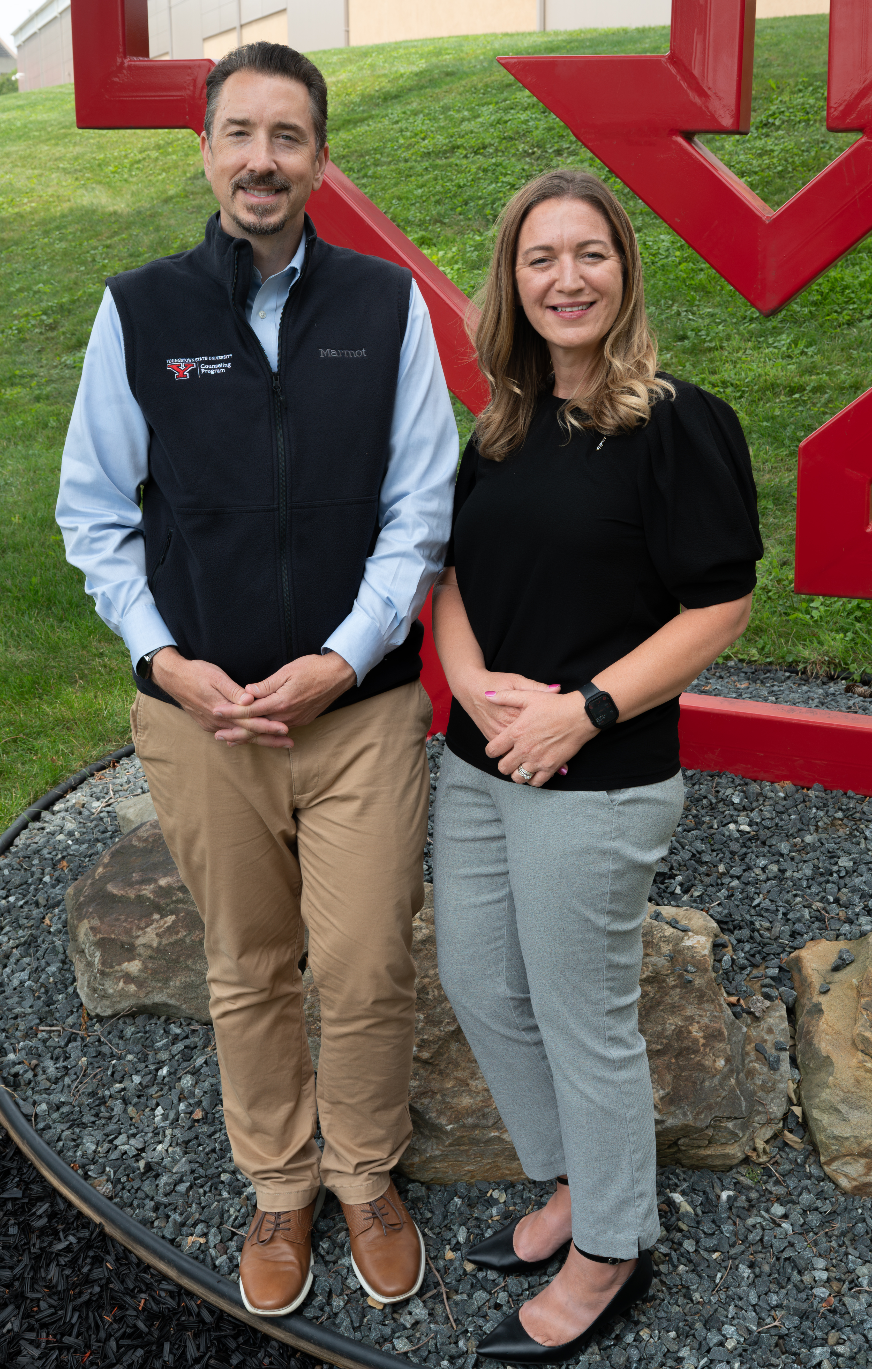 Jake Protivnak and Meghan Bileci pose in fornt of a YSU 