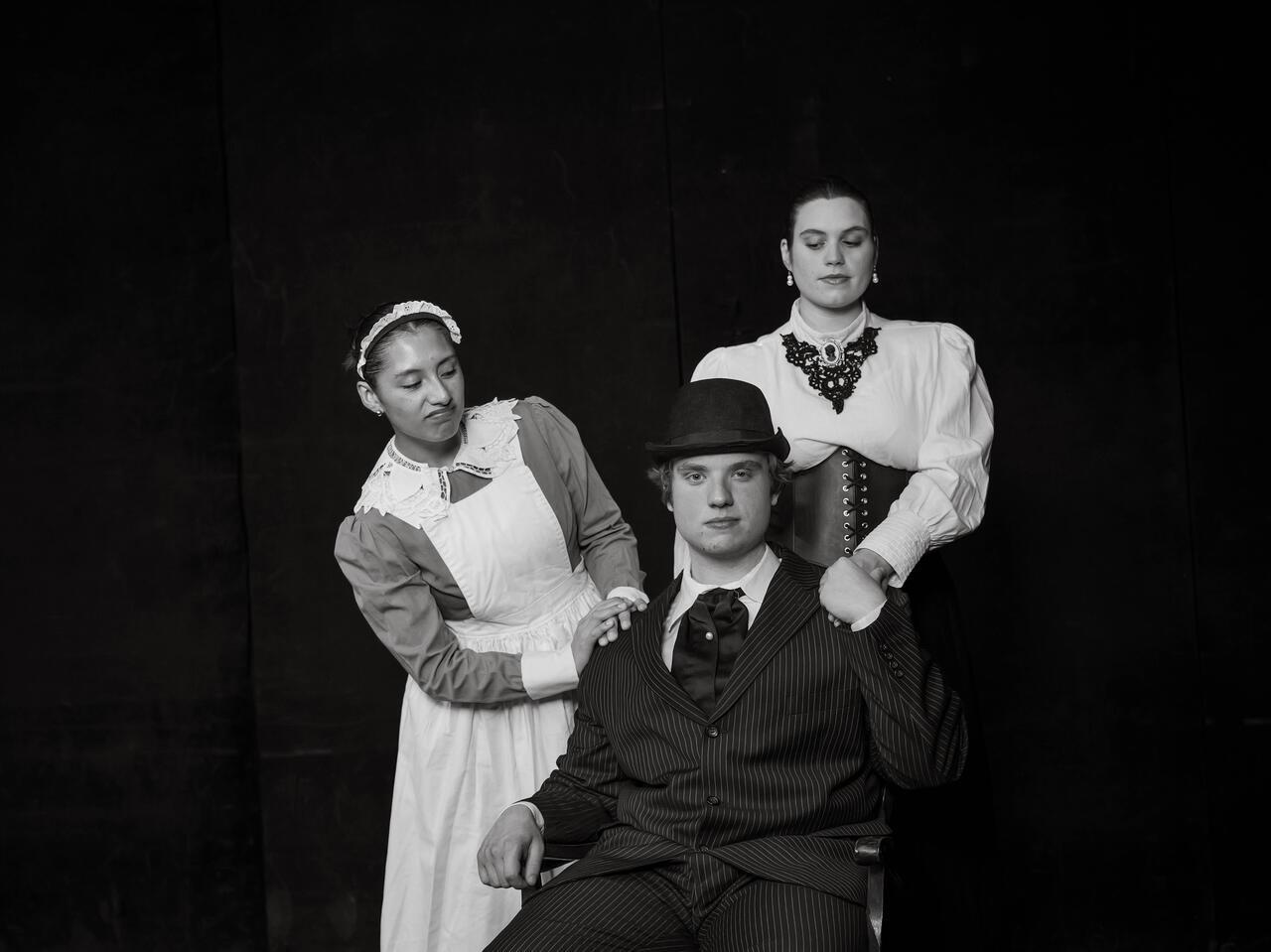 Black and white publicity photo of cast members in costume