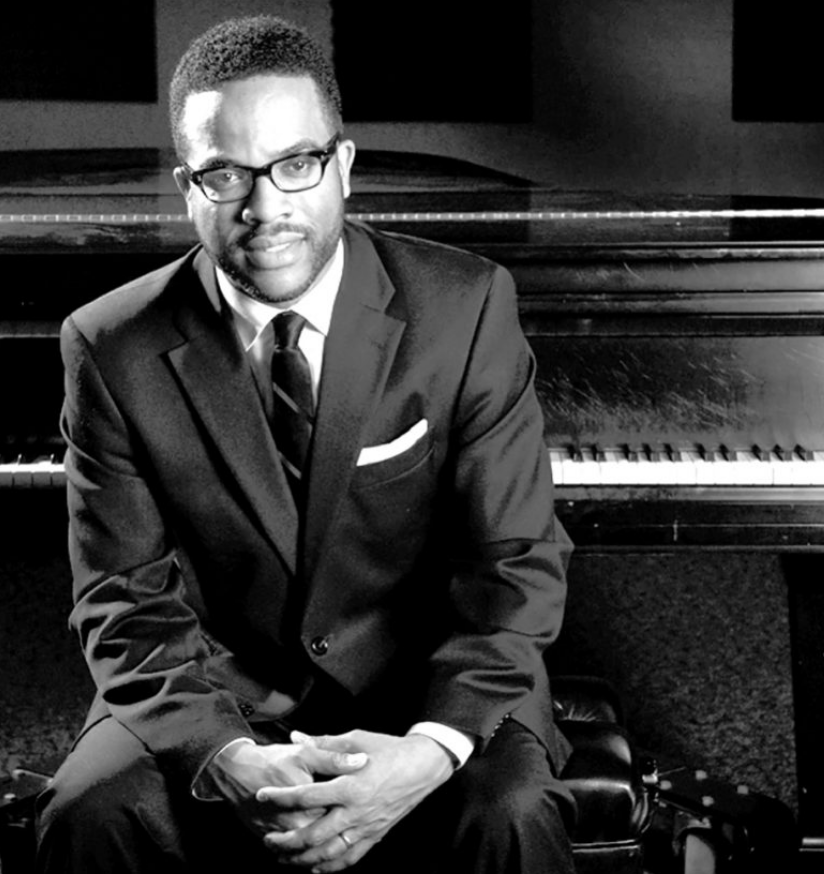 Alton Merrell sitting by a piano