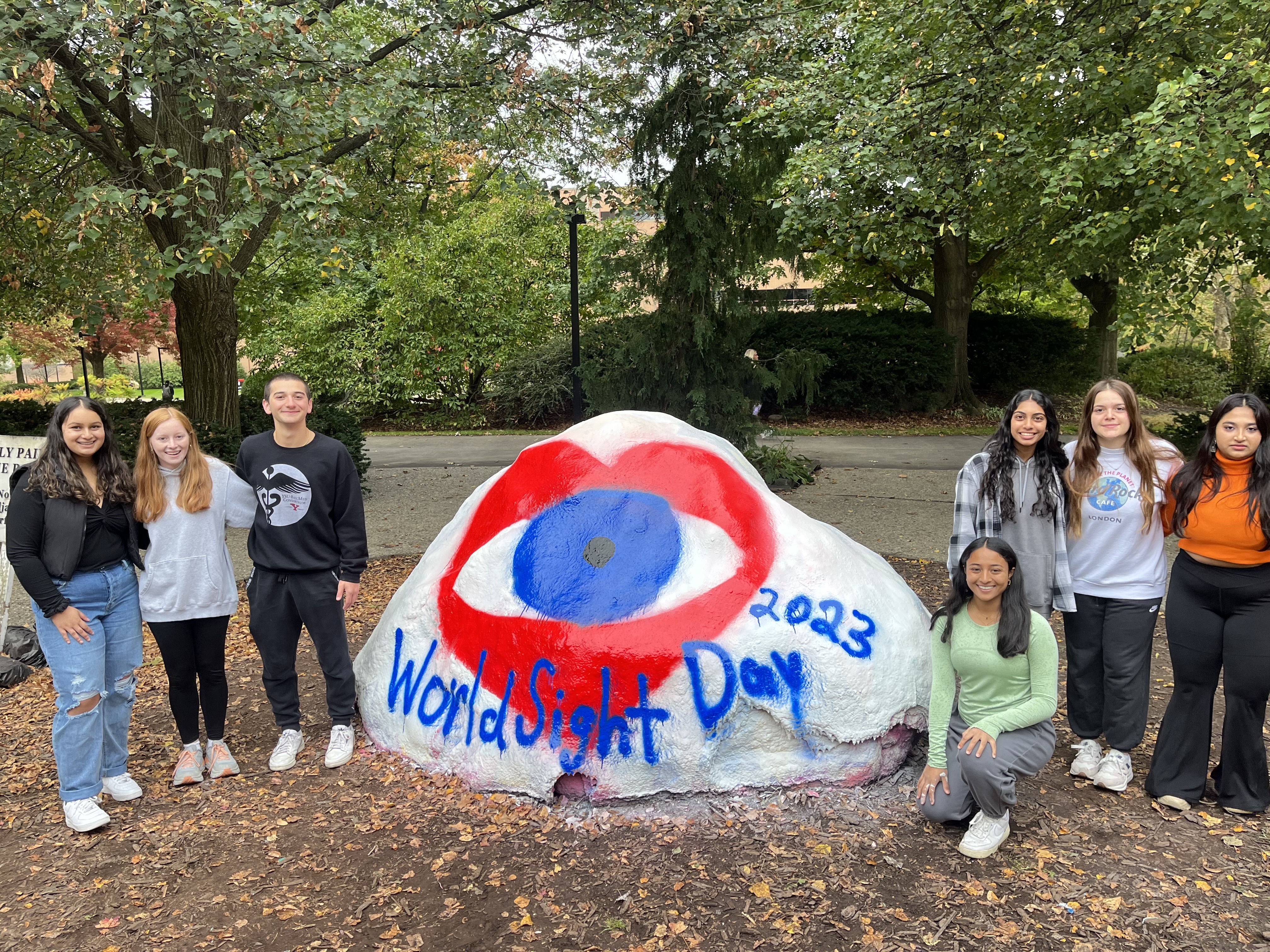 students for sight in front of the rock