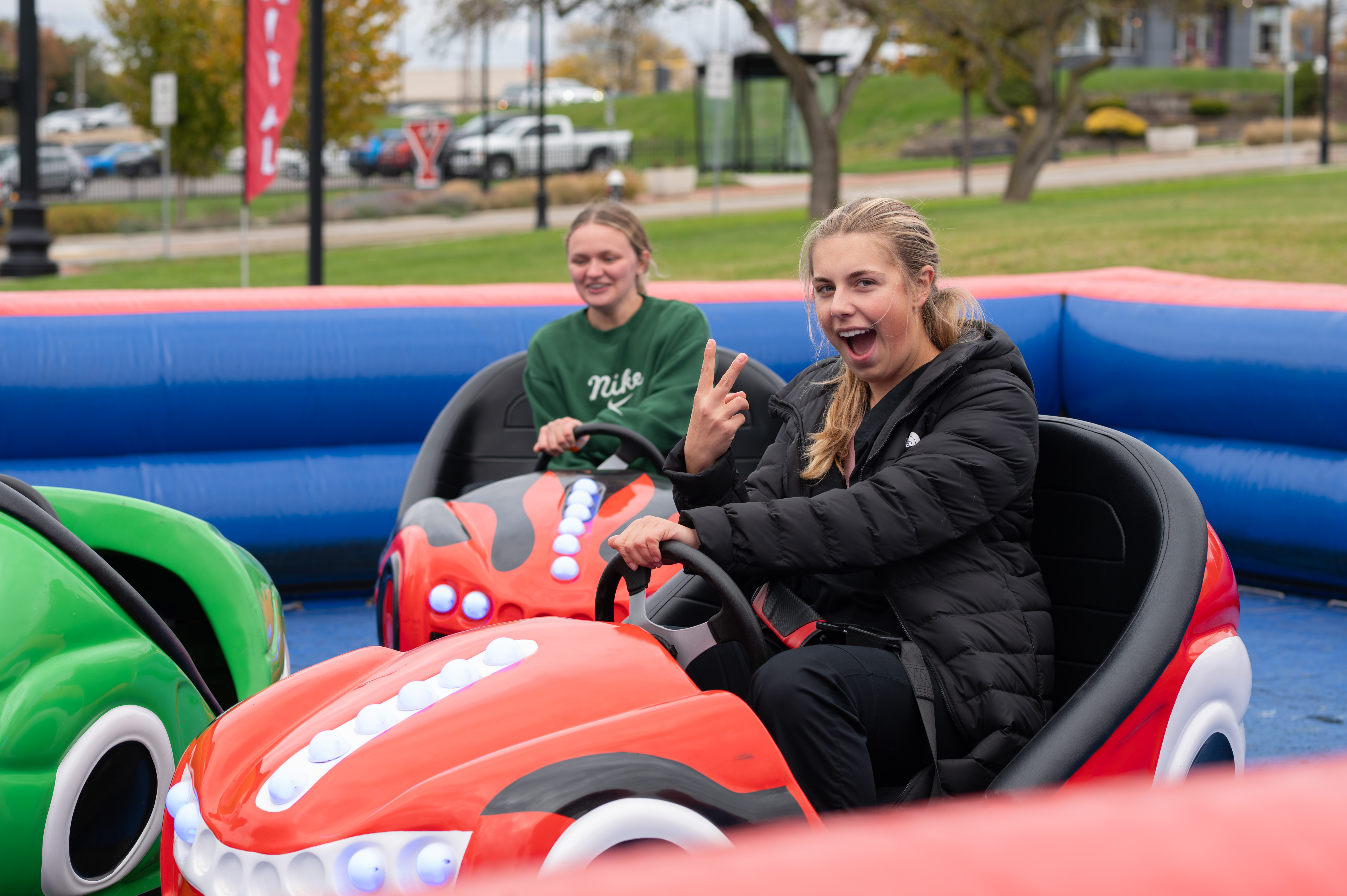 two bumper kart riding students in inflatable track