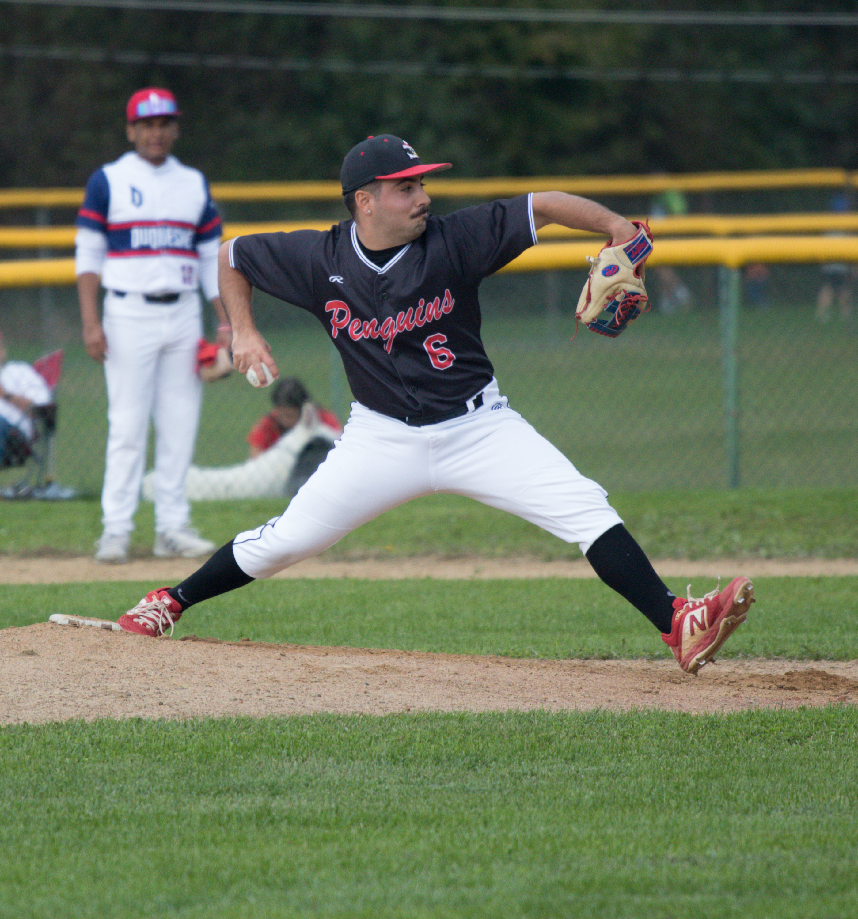 University player pitching a baseball