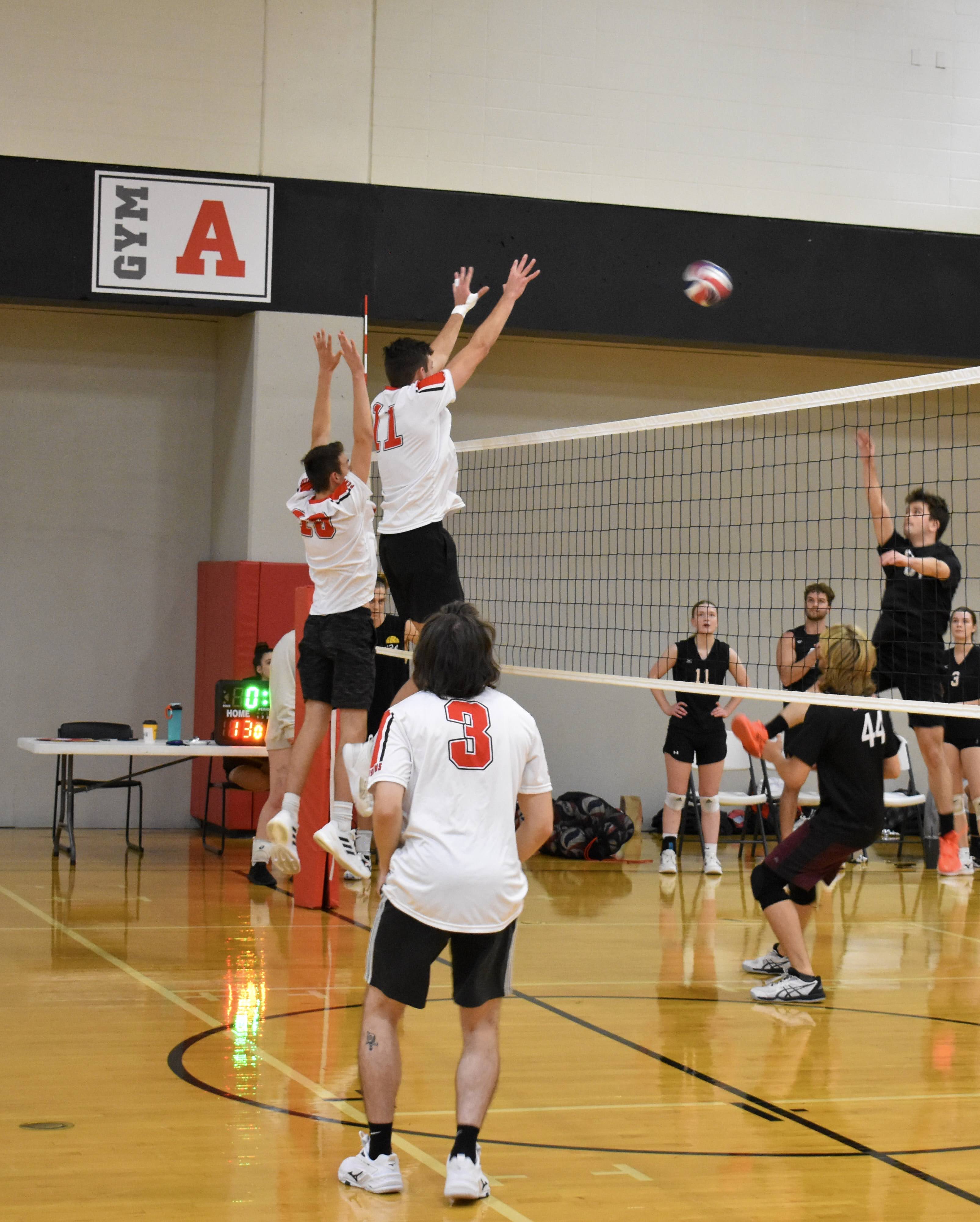 mens volleyball team in a huddle