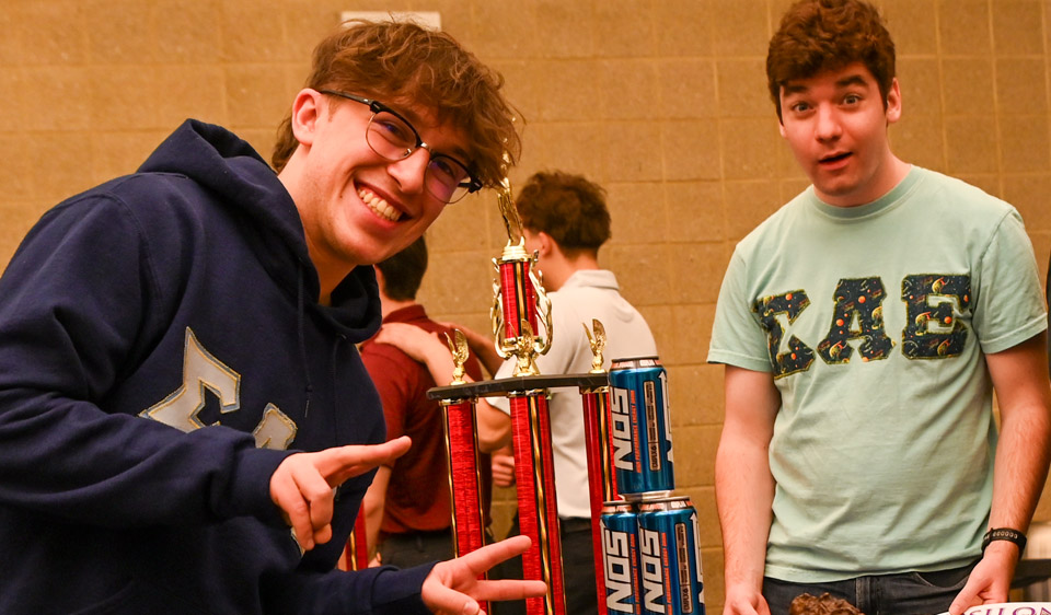 2 Sigma Alpha Epsilon members with trophie