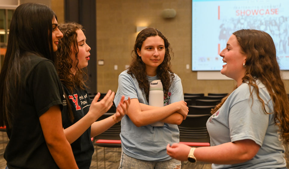 2 sorority girls talking with students