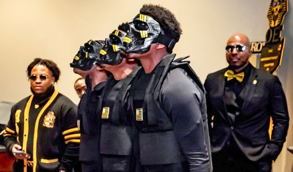 3 Alpha Phi Alpha members with masks