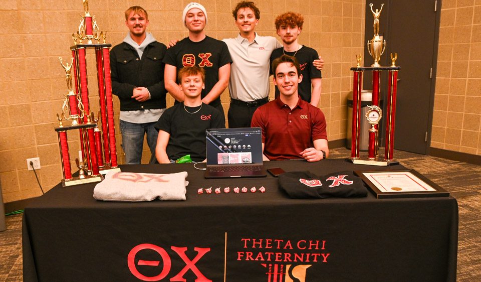 6 Theta Chi members with trophies