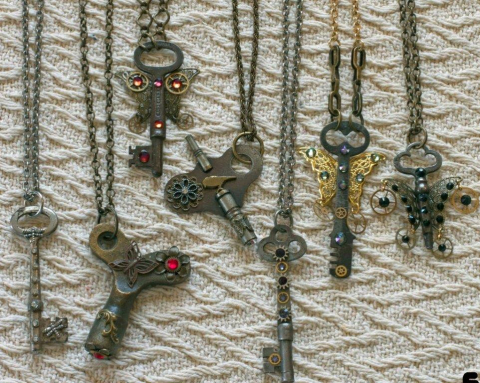Key necklaces with flowers and butterfly wings designed onto the key