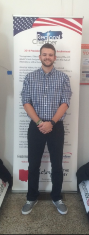 Male student posing in front of Regional Chamber sign