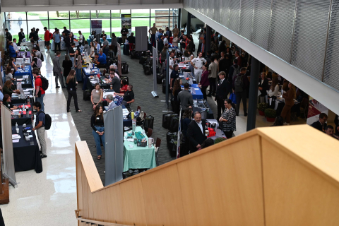 Photo of the Atrium in Williamson Hall, filled with students meeting with employers