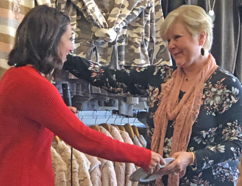 Two women shaking hands 
