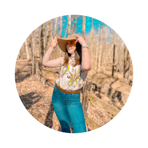 Abby Crow poses in a setting of trees
