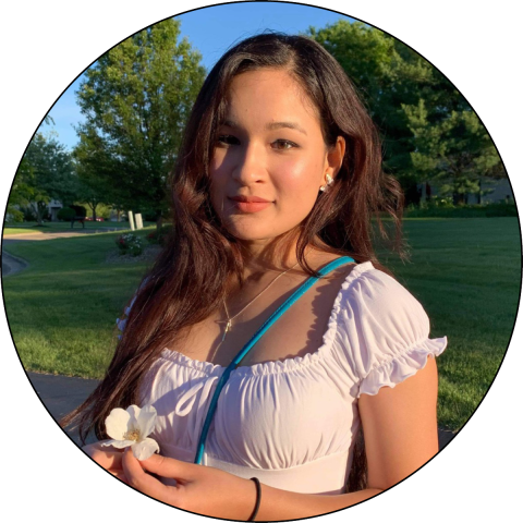 Photo of Shreeya Manandhar outside holding a flower.