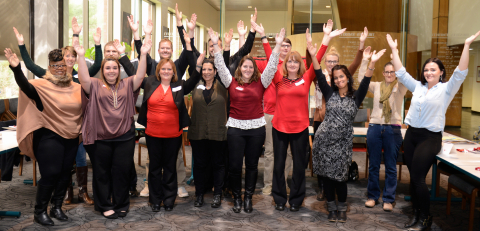 New employees give the “Y” sign
