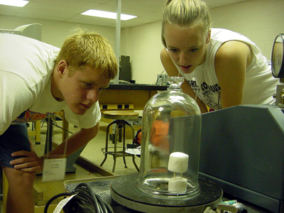 Summer Honors Institute students study the effects of vacuum on marshmallows.