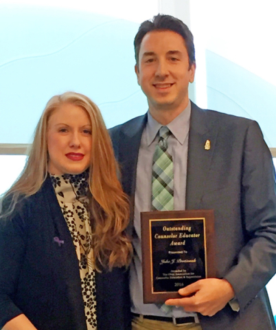 Counselor-Educator of the Year Jake Protivnak, left, celebrates his award with Christie Jenkins, president of the Ohio Association of Counselor Education & Supervision. 