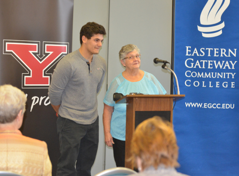 Paula Kacir and her grandson, Michael, speak at a news conference announcing the first recipient of a tuition waiver under the Give Back, Go Forward program.