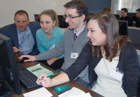 Dave Blasko, HBK, assists students from Cardinal Mooney High School, in the JA Titan Business Challenge competition.