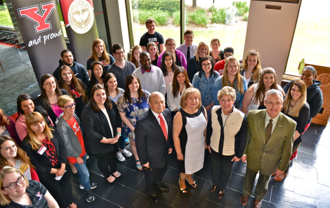 Shorty and Elba Navarro, center front, stand with President Jim and Ellen Tressel after announcing a $1 million gift to the university, part of which will go to expand campus employment opportunities for students. They are surrounded by several YSU student employees.