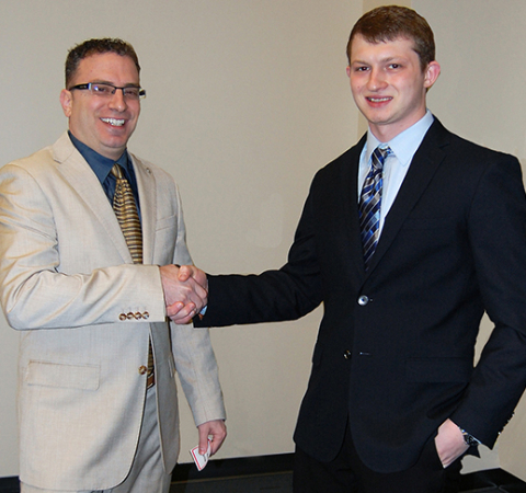 Pasquale LaRocca, manager of strategic marketing and branding, AVI Foodsystems, works with Robert Grahovac, junior, international business major from Columbiana, as a mentor during Shadow Day. 
