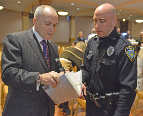 Raymond Kelly, former commissioner of the New York Police Department and a leading expert on national security, presented the YSU Skeggs Lecture earlier this month in Stambaugh Auditorium. Above, he signs a copy of his book for YSU Police Officer Adam Skovira. Below, he meets with President Jim Tressel.