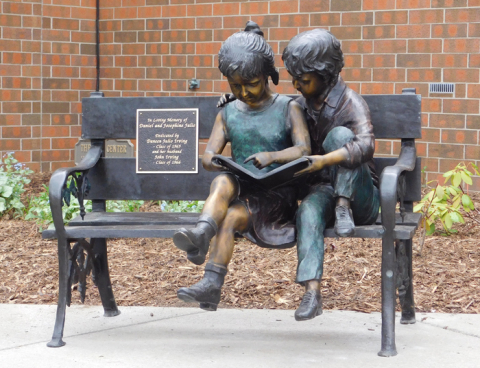 "Two Children on a Bench" is one of three sculptures donated by YSU alum John Irving and installed on campus this spring. This piece is located near Fedor Hall.