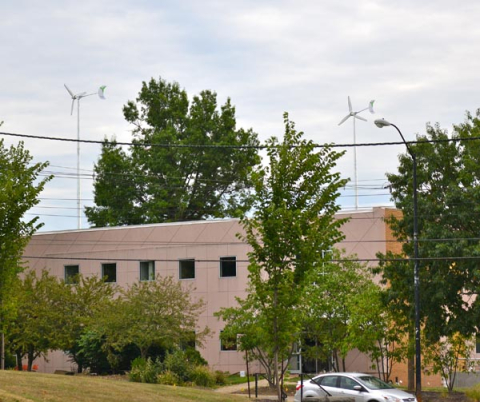 This photo, taken facing east from Wick Avenue, shows the two wind turbines behind Melnick Hall.