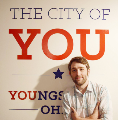 YSU professor RJ Thompson with City of You sign