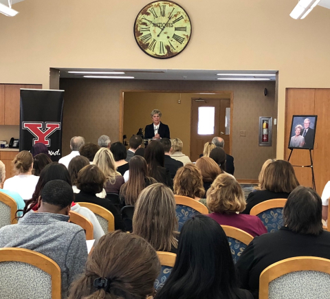 About 50 people, including many caregivers, look on as Ellen Tressel announces the creation of a new scholarship at Briarfield Manor in Austintown.