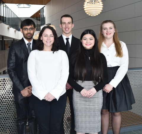 Five students pose in the Williamson College of Business Administration 