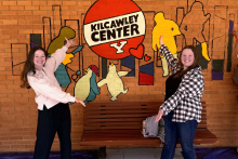 Lauren Barrett and Emma Strope-Downs in front of the Kilcawley mural