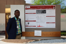 Solomon Atta poses with his research poster at the Society for the Applied Spectroscopy conference