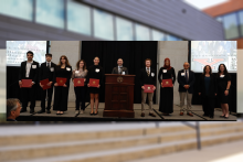 YSU students pose on the stage with diploma covers at the Global Trade in Action: Highlighting Ohio Exporters event held at the Ohio Statehouse