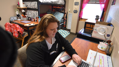 Resident in room at laptop